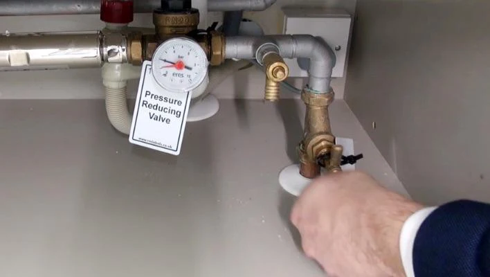 Internal stop valve and pressure reducing valve under a kitchen sink